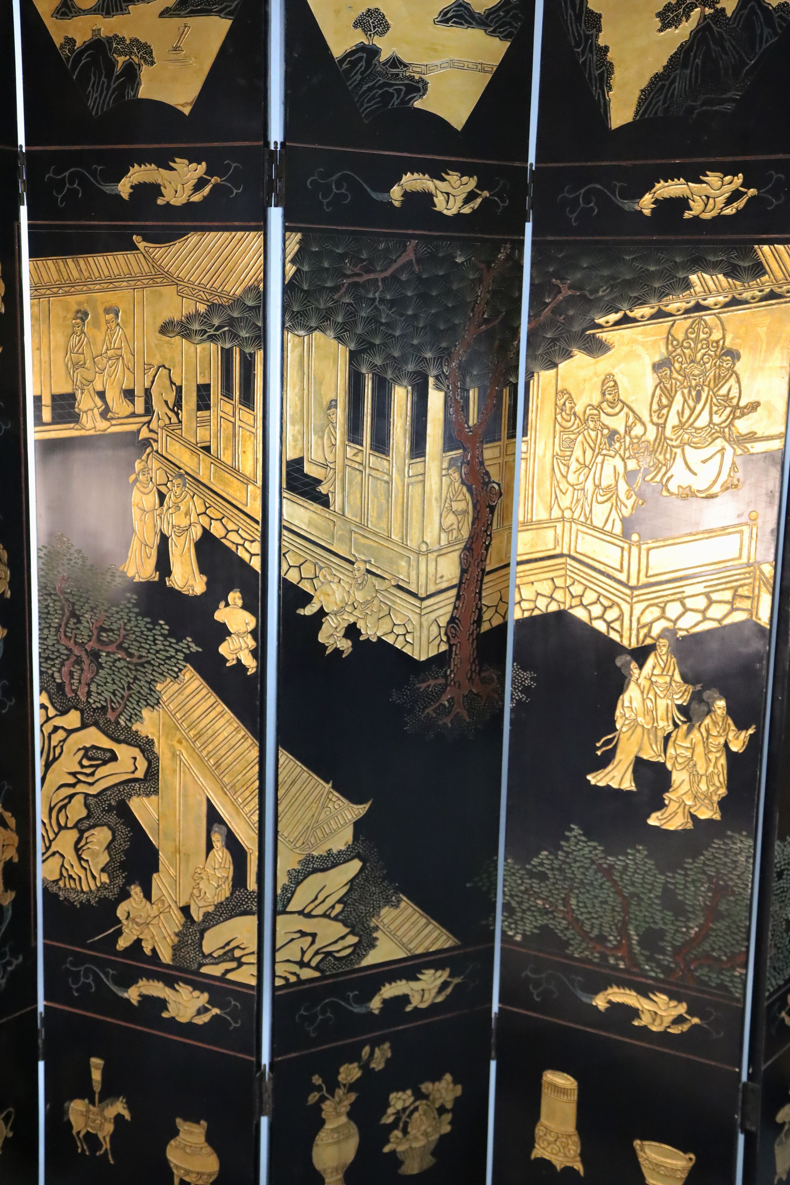 A late 19th century Chinese Coromandel lacquer eight fold dressing screen, each panel W.1ft 4in. H.6ft 9in.